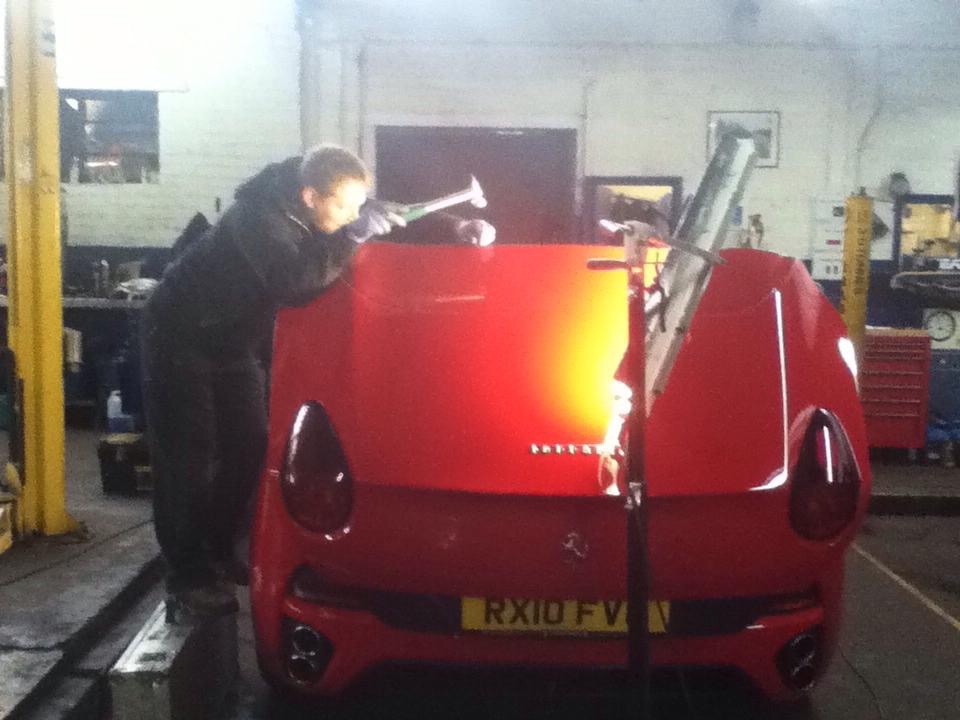 Ferrari being repaired in the workshop using paintless dent removal